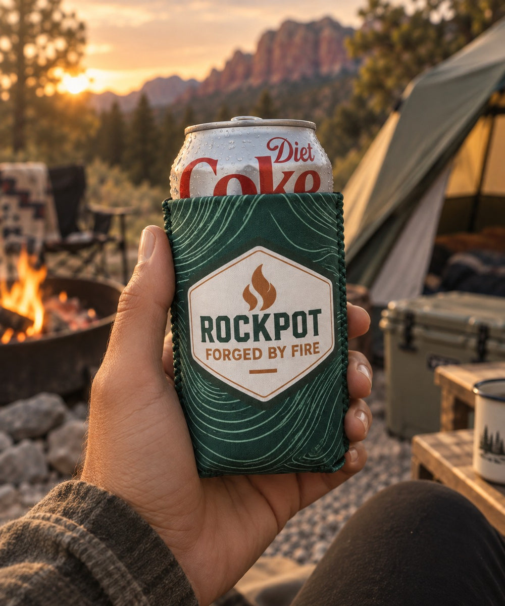 RockPot Coozie held at a campsite at sunset
